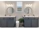 Modern bathroom with double vanity and large mirrors at 4697 Antrim Dr, Sarasota, FL 34240