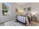 Bright bedroom with a metal bed frame and window at 4697 Antrim Dr, Sarasota, FL 34240