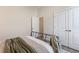 Bedroom with a metal bed frame and white doors at 4697 Antrim Dr, Sarasota, FL 34240