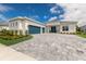 Two-story house with teal garage doors and a paved driveway at 4697 Antrim Dr, Sarasota, FL 34240