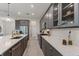 Bright kitchen with gray cabinets, quartz countertops, and stainless steel appliances at 4697 Antrim Dr, Sarasota, FL 34240