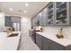 Modern kitchen with gray cabinets, quartz countertops and stainless steel appliances at 4697 Antrim Dr, Sarasota, FL 34240