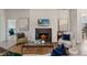 Spacious living room with a fireplace and views into a bedroom at 4697 Antrim Dr, Sarasota, FL 34240