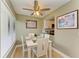 Bright dining area with white table and chairs, and view of kitchen at 4918 25Th W St # 102, Bradenton, FL 34207