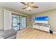 Living room featuring a large TV, white media console, and access to a patio at 4918 25Th W St # 102, Bradenton, FL 34207