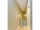 Simple wooden staircase with light walls and a metal handrail at 4918 25Th W St # 102, Bradenton, FL 34207