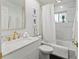 Elegant bathroom with marble vanity, gold fixtures, and a white bathtub at 5107 86Th Street W Ct, Bradenton, FL 34210
