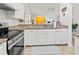 Modern kitchen with granite countertops, stainless steel appliances, and white cabinets at 5107 86Th Street W Ct, Bradenton, FL 34210