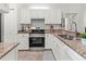Bright kitchen features granite countertops, stainless steel appliances, and white cabinetry at 5107 86Th Street W Ct, Bradenton, FL 34210