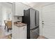 Kitchen boasts granite countertops, stainless steel refrigerator, and white cabinets at 5107 86Th Street W Ct, Bradenton, FL 34210