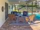 Covered patio with seating area adjacent to refreshing pool at 5107 86Th Street W Ct, Bradenton, FL 34210