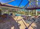 Inviting pool and patio area with covered seating and lounge chairs at 5107 86Th Street W Ct, Bradenton, FL 34210
