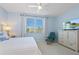 Bright bedroom featuring a large TV and ample closet space at 5240 Hyland Hills Ave # 1411, Sarasota, FL 34241