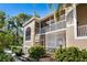 Condo building exterior, showcasing screened patio and landscaping at 5240 Hyland Hills Ave # 1411, Sarasota, FL 34241