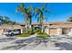 Condo building exterior, showcasing landscaping and parking at 5240 Hyland Hills Ave # 1411, Sarasota, FL 34241