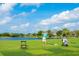 Golf course with putting green, golfers, and scenic water views at 5240 Hyland Hills Ave # 1411, Sarasota, FL 34241