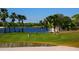 Golf putting green with players and a pond at 5240 Hyland Hills Ave # 1411, Sarasota, FL 34241