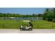 Golf course with a golf cart and practice area at 5240 Hyland Hills Ave # 1411, Sarasota, FL 34241