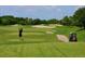 Elevated view of a golfer teeing off on a lush course at 5240 Hyland Hills Ave # 1411, Sarasota, FL 34241