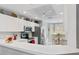 Modern kitchen boasts stainless steel appliances and white cabinetry at 5240 Hyland Hills Ave # 1411, Sarasota, FL 34241