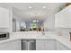 Kitchen features a breakfast bar and view of living room at 5240 Hyland Hills Ave # 1411, Sarasota, FL 34241