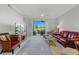 Living room features a view, comfy seating, and a large TV at 5240 Hyland Hills Ave # 1411, Sarasota, FL 34241