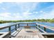 Scenic wooden pier with a bench overlooking the lake at 5240 Hyland Hills Ave # 1411, Sarasota, FL 34241