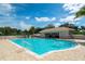 Refreshing community pool with lounge chairs and shaded seating areas at 5240 Hyland Hills Ave # 1411, Sarasota, FL 34241