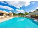 Large community pool with surrounding patio and lounge chairs at 5240 Hyland Hills Ave # 1411, Sarasota, FL 34241
