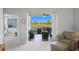 Sitting room opens to a screened patio overlooking a tranquil lake at 5240 Hyland Hills Ave # 1411, Sarasota, FL 34241