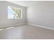 Simple bedroom with wood-like floors and window at 5587 Farmington Ave, North Port, FL 34288
