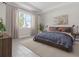 Bright bedroom with wood-like floors and large window at 5587 Farmington Ave, North Port, FL 34288