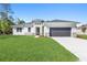 Single-story home with a two-car garage and manicured lawn at 5587 Farmington Ave, North Port, FL 34288