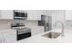 Modern kitchen with stainless steel appliances and white cabinetry at 5587 Farmington Ave, North Port, FL 34288
