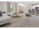 Open concept living space with gray tile flooring and ample natural light at 5587 Farmington Ave, North Port, FL 34288