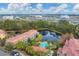 Aerial view of community featuring pool, pond, and lush landscaping at 5700 Bentgrass Dr # 16-211, Sarasota, FL 34235