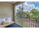 Relaxing screened balcony with a bench and tropical view at 5700 Bentgrass Dr # 16-211, Sarasota, FL 34235
