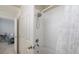 Clean bathroom with tub shower combo and white tile at 5700 Bentgrass Dr # 16-211, Sarasota, FL 34235