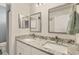 Modern bathroom with double vanity and granite countertop at 5700 Bentgrass Dr # 16-211, Sarasota, FL 34235