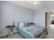Second bedroom with ceiling fan and gray walls at 5700 Bentgrass Dr # 16-211, Sarasota, FL 34235