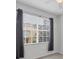 Bedroom features a large window and gray curtains at 5700 Bentgrass Dr # 16-211, Sarasota, FL 34235