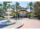 Elegant community center with a fountain and circular driveway at 5700 Bentgrass Dr # 16-211, Sarasota, FL 34235