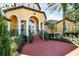 Community center entrance with columns and landscaping at 5700 Bentgrass Dr # 16-211, Sarasota, FL 34235