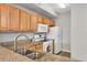 Kitchen with granite countertops and wood cabinets at 5700 Bentgrass Dr # 16-211, Sarasota, FL 34235