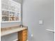Laundry area with granite countertop and wood cabinets at 5700 Bentgrass Dr # 16-211, Sarasota, FL 34235
