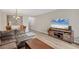 Spacious living room with L-shaped sofa and large TV at 5700 Bentgrass Dr # 16-211, Sarasota, FL 34235
