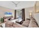 Living room with L-shaped sofa and access to balcony at 5700 Bentgrass Dr # 16-211, Sarasota, FL 34235
