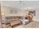Living room with L-shaped sofa, coffee table, and dining area at 5700 Bentgrass Dr # 16-211, Sarasota, FL 34235