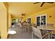 Covered patio with tables and chairs at 5700 Bentgrass Dr # 16-211, Sarasota, FL 34235
