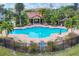 Resort-style pool with surrounding patio furniture and lush landscaping at 5700 Bentgrass Dr # 16-211, Sarasota, FL 34235